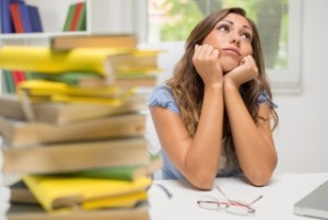 Portrait of beautiful teenage girl thinking and bored of a learning.