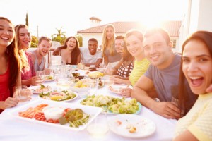 Group Of Young People Enjoying Outdoor Summer Meal