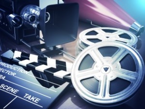 Video, movie, cinema vintage concept. Retro camera, reels and clapperboard. 3d