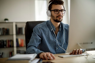 person sitting in front of monitor